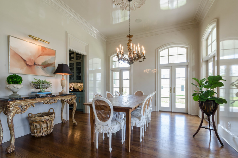 Photo of a mid-sized traditional separate dining room in New Orleans with beige walls, dark hardwood floors and no fireplace.
