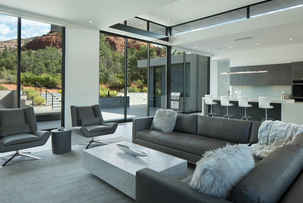 Design ideas for a mid-sized contemporary open concept living room in Phoenix with white walls and grey floor.