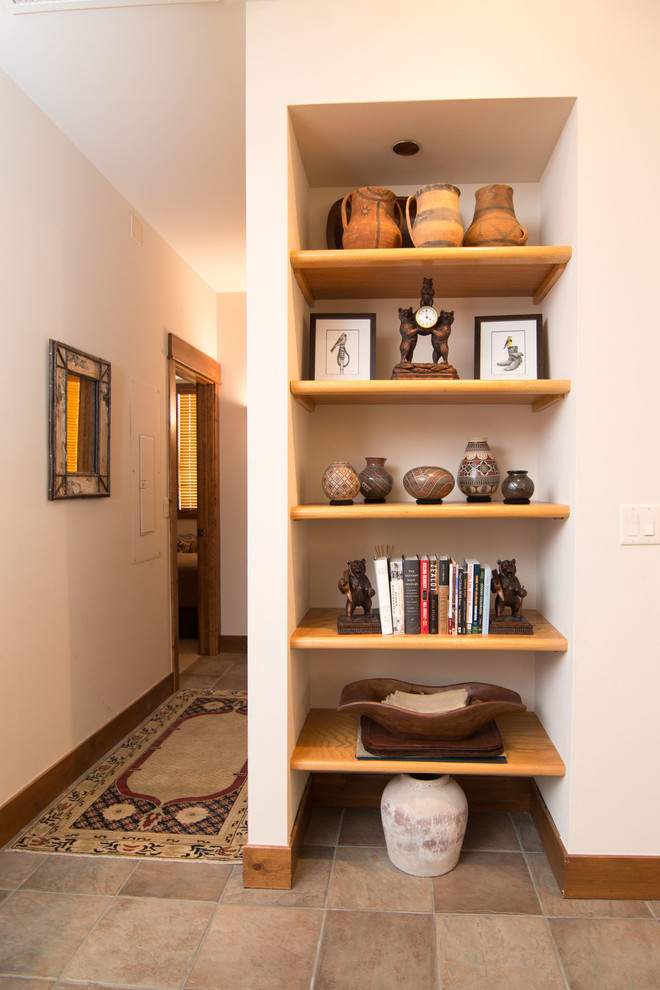 This is an example of a country hallway in Denver with ceramic floors and beige floor.