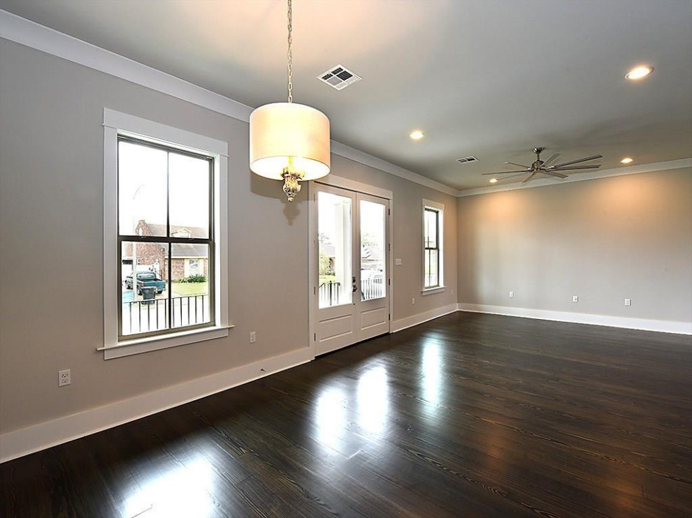Photo of a large traditional foyer in New Orleans with beige walls, dark hardwood floors, a double front door, a blue front door and brown floor.