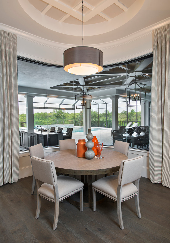 Example of a transitional dark wood floor dining room design in Miami with gray walls