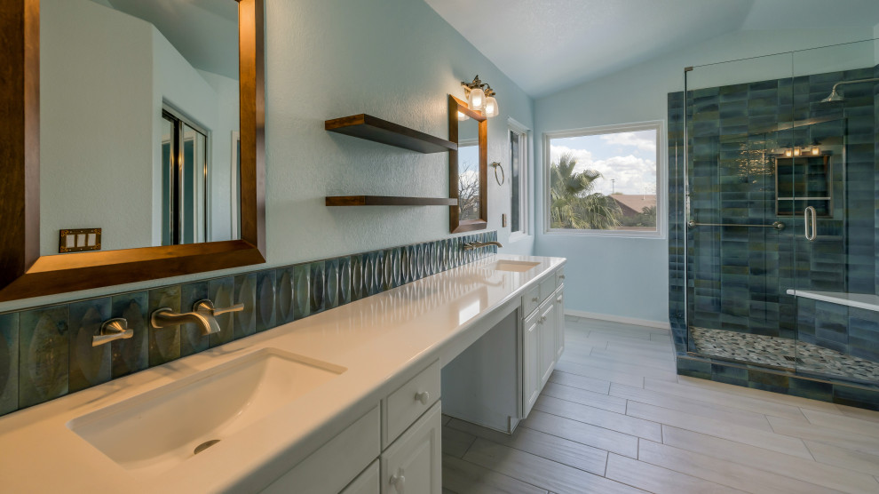 Design ideas for a large contemporary ensuite bathroom in Phoenix with shaker cabinets, white cabinets, an alcove shower, blue tiles, ceramic tiles, blue walls, porcelain flooring, a submerged sink, engineered stone worktops, white floors, a hinged door, white worktops, a wall niche, double sinks and a built in vanity unit.