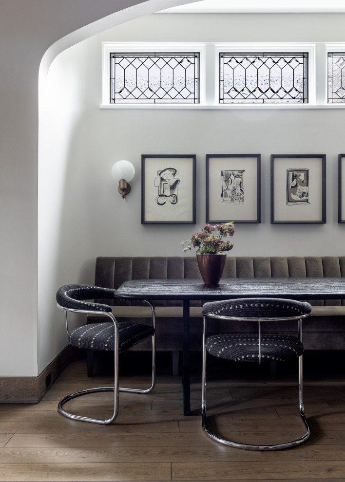 Inspiration for a transitional medium tone wood floor and brown floor breakfast nook remodel in Chicago with white walls