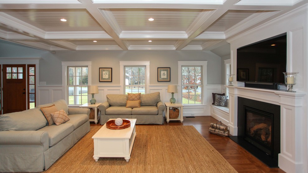 This is an example of an expansive arts and crafts open concept home theatre in Other with grey walls, medium hardwood floors and a built-in media wall.