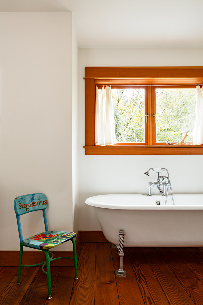 Photo of a traditional bathroom in Portland with a claw-foot tub, white walls and medium hardwood floors.
