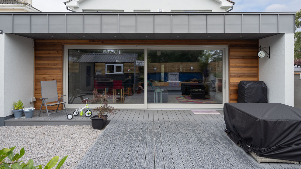 Photo of a large modern backyard patio in Dublin with decking.