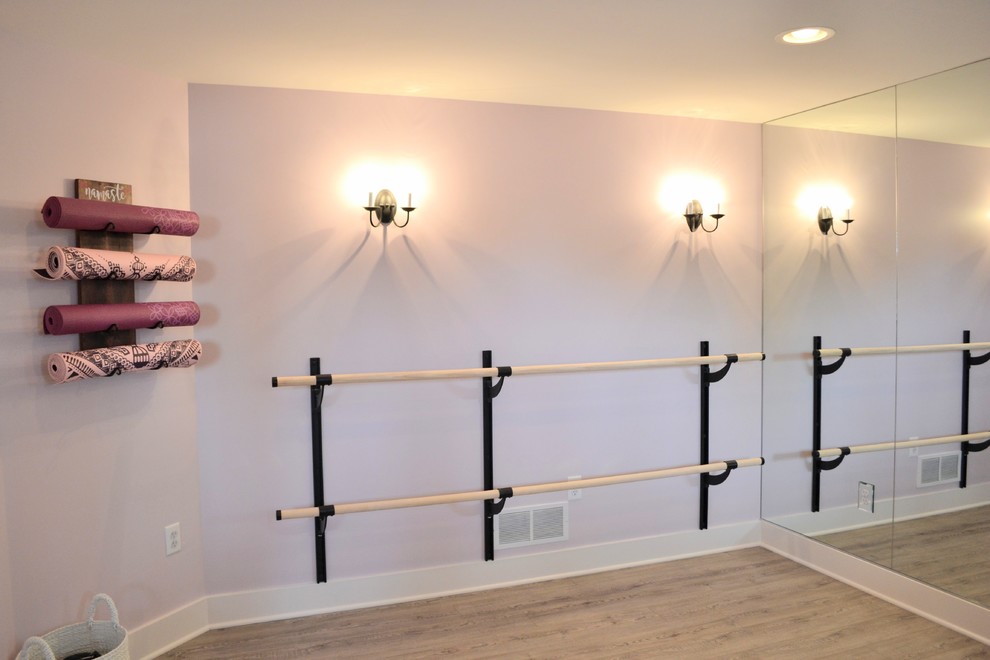 Photo of a mid-sized country home gym in Detroit with purple walls and vinyl floors.