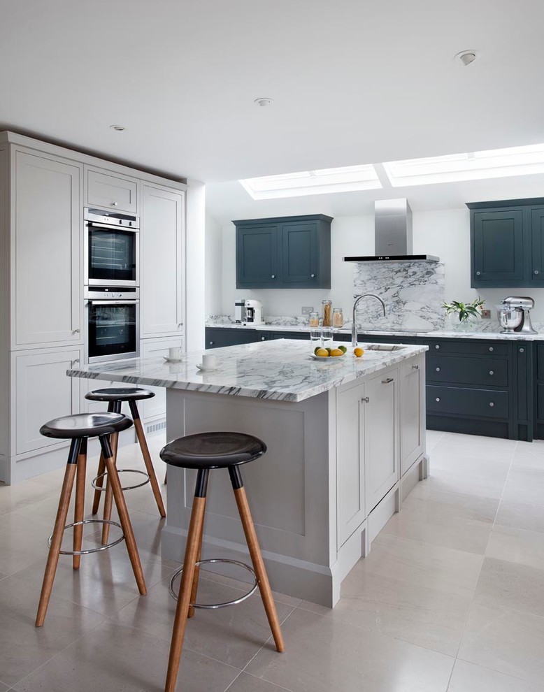 Design ideas for a mid-sized traditional eat-in kitchen in Dublin with an integrated sink, shaker cabinets, grey cabinets, marble benchtops, grey splashback, stone slab splashback, stainless steel appliances, terra-cotta floors and with island.