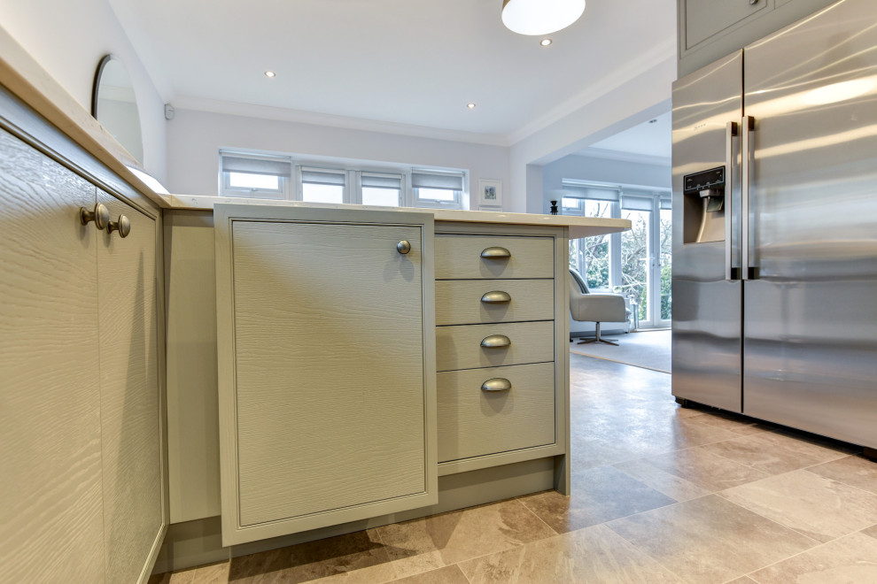Design ideas for a mid-sized modern l-shaped eat-in kitchen in Sussex with an undermount sink, flat-panel cabinets, grey cabinets, quartzite benchtops, blue splashback, glass sheet splashback, black appliances, vinyl floors, a peninsula, grey floor and white benchtop.