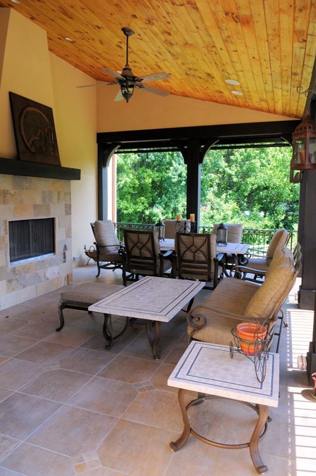 Photo of a large mediterranean backyard screened-in verandah in DC Metro with tile and a roof extension.