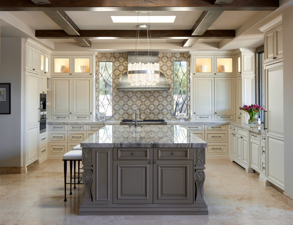 Photo of an expansive transitional u-shaped kitchen in Phoenix with an undermount sink, raised-panel cabinets, beige cabinets, multi-coloured splashback, panelled appliances, porcelain floors, with island, beige floor, grey benchtop and coffered.