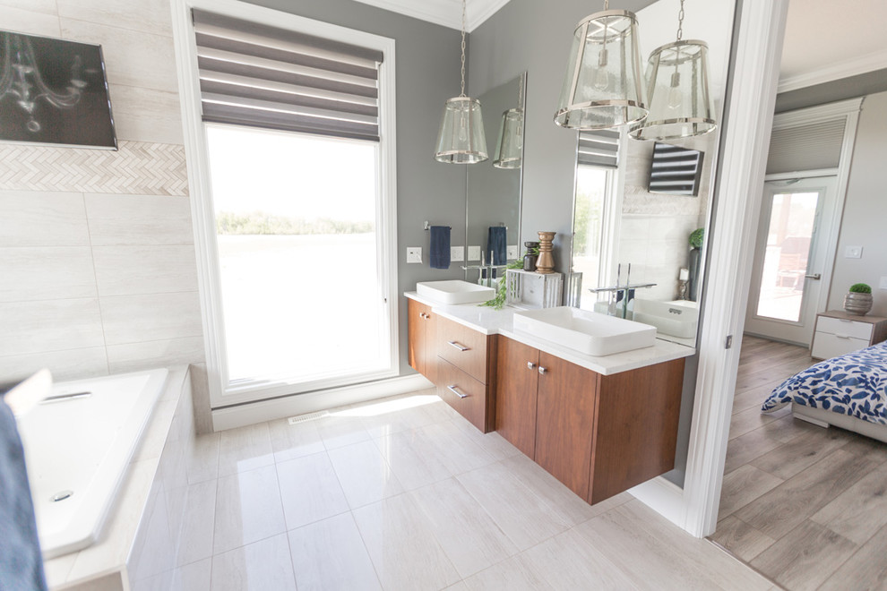 Example of a transitional master beige tile beige floor bathroom design with flat-panel cabinets, medium tone wood cabinets, gray walls and a vessel sink