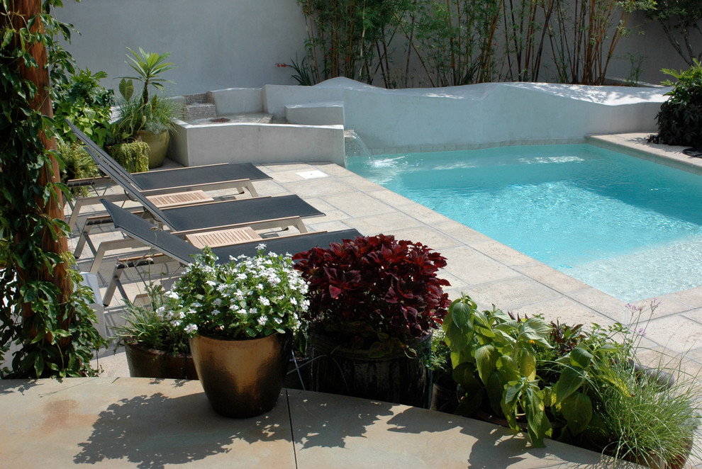 Small beach style courtyard custom-shaped pool in Birmingham with concrete pavers.
