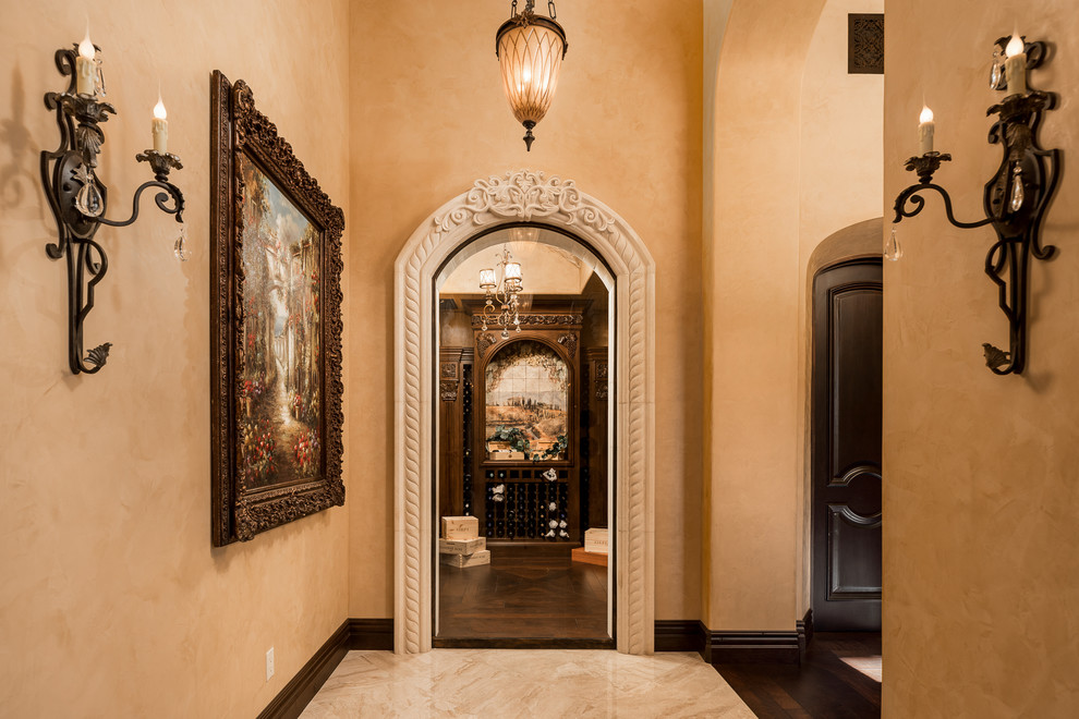 This is an example of an expansive country hallway in Phoenix with beige walls, marble floors and multi-coloured floor.