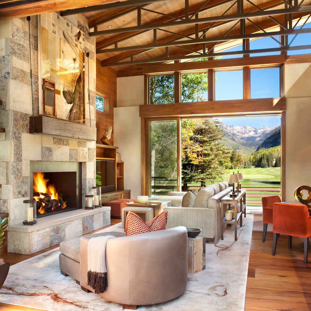 Design ideas for a contemporary open concept living room in Denver with a stone fireplace surround.