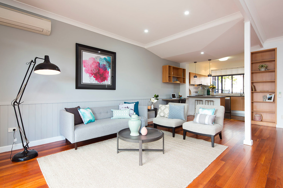 Transitional open concept living room in Brisbane with grey walls and medium hardwood floors.