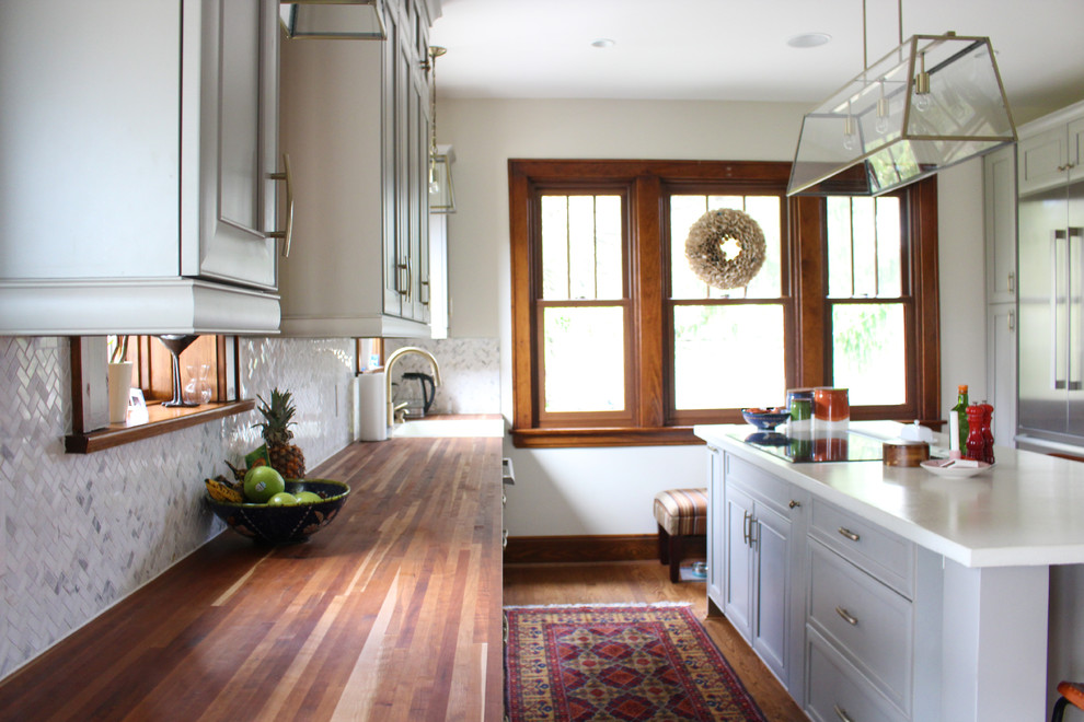 Example of a mid-sized transitional dark wood floor kitchen design in Cincinnati with a drop-in sink, gray cabinets, concrete countertops, white backsplash, stainless steel appliances and an island