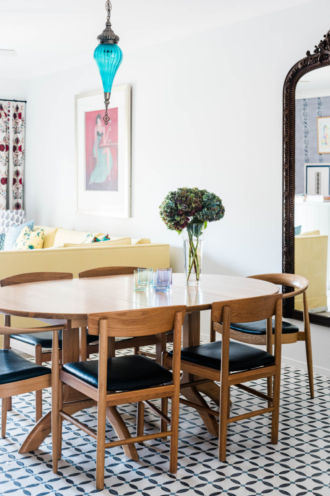 This is an example of an eclectic dining room in Brisbane with white walls and multi-coloured floors.
