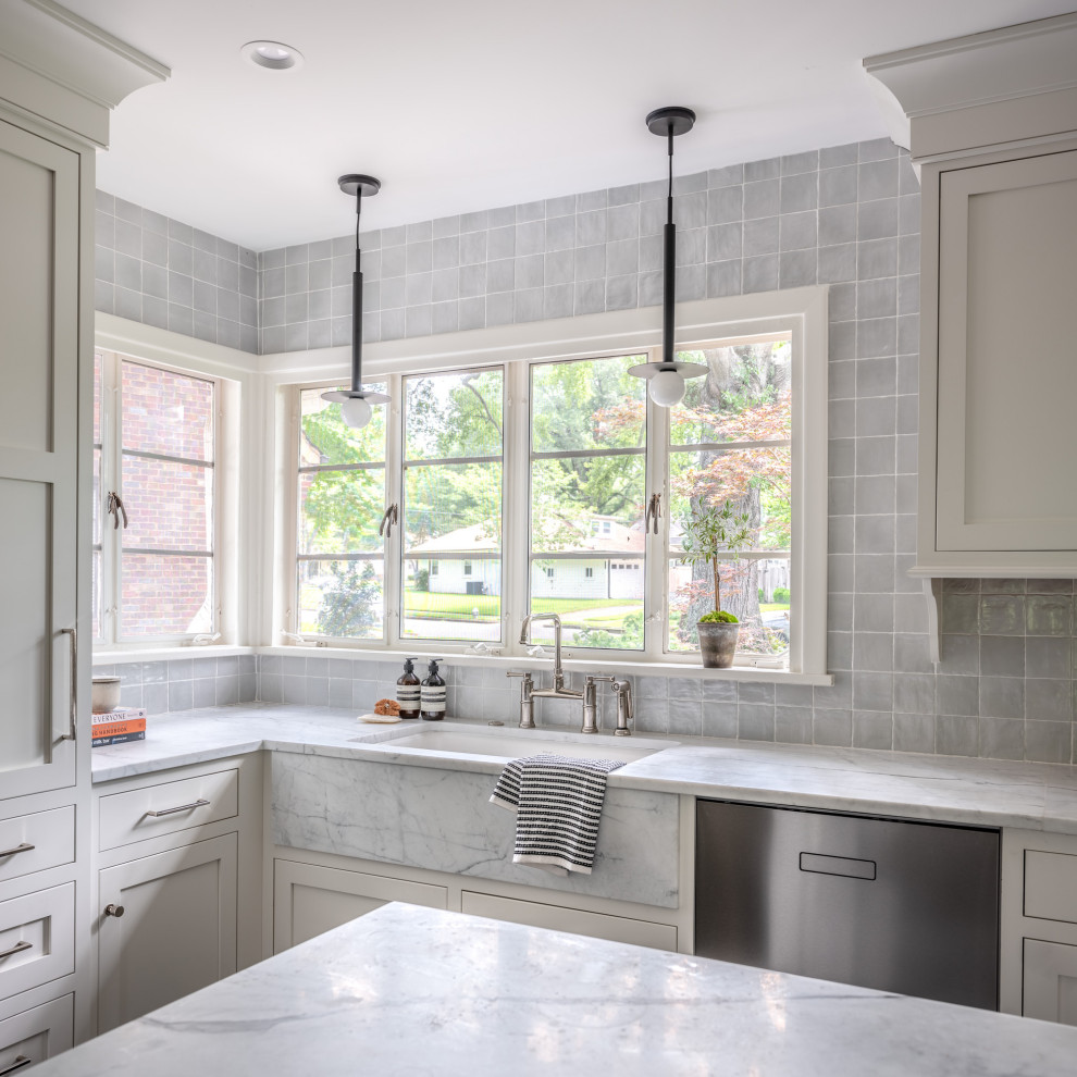 Example of a mid-sized transitional u-shaped cement tile floor and gray floor eat-in kitchen design with a drop-in sink, shaker cabinets, white cabinets, quartzite countertops, gray backsplash, porcelain backsplash, stainless steel appliances, an island and multicolored countertops
