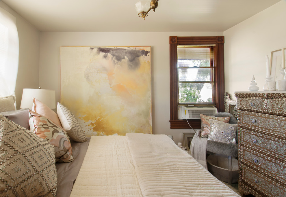 This is an example of an eclectic bedroom in Los Angeles with white walls.