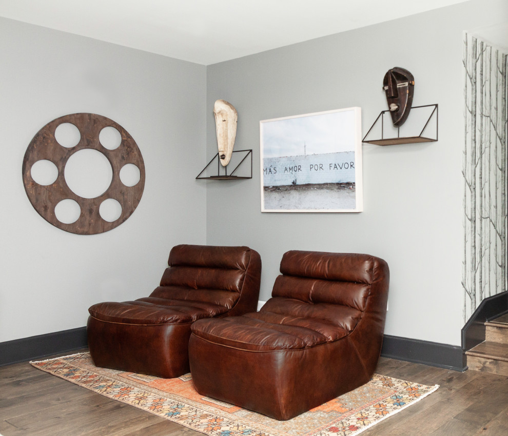This is an example of a transitional basement in New York with grey walls, medium hardwood floors and brown floor.