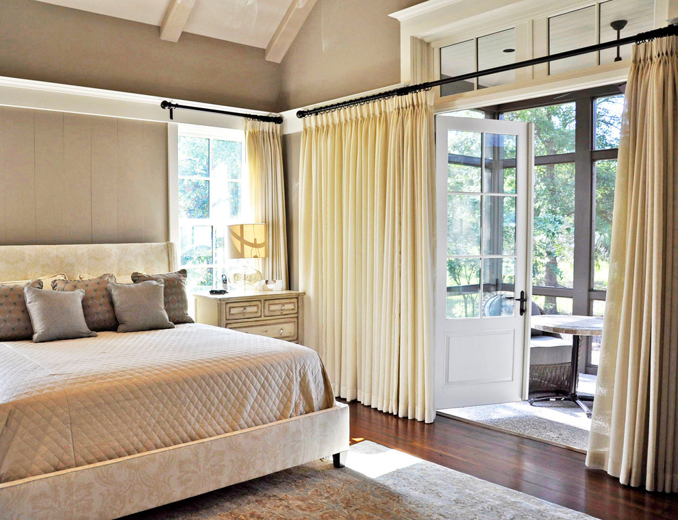 This is an example of a mid-sized traditional master bedroom in Charleston with beige walls and dark hardwood floors.