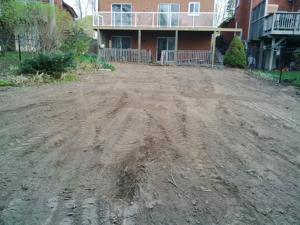 This is an example of a mid-sized full sun backyard landscaping.