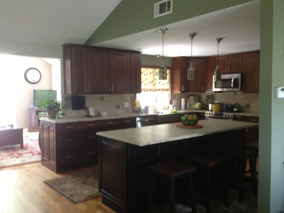 Eat-in kitchen - mid-sized eclectic l-shaped medium tone wood floor eat-in kitchen idea in Bridgeport with an undermount sink, shaker cabinets, dark wood cabinets, granite countertops, beige backsplash, ceramic backsplash, stainless steel appliances and an island