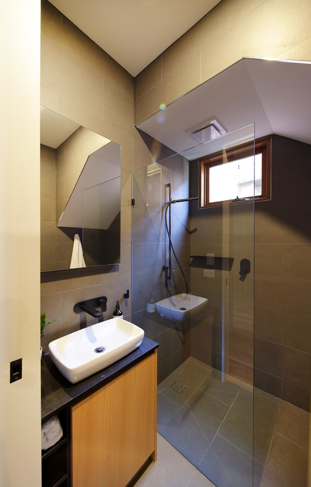 Design ideas for a small contemporary 3/4 bathroom in Melbourne with glass-front cabinets, an alcove shower, a one-piece toilet, gray tile, ceramic tile, grey walls, ceramic floors, an integrated sink, engineered quartz benchtops, grey floor and a hinged shower door.