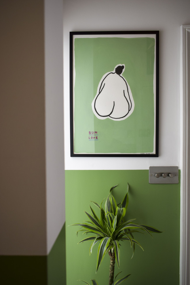 Medium sized eclectic hallway in London with green walls.