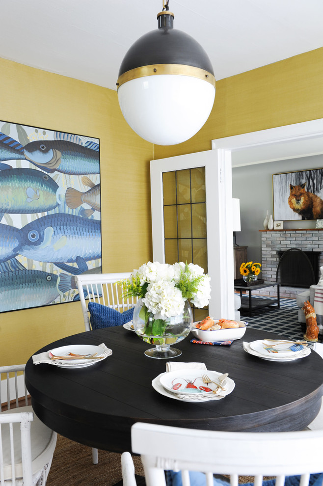 Design ideas for a beach style dining room in Other with yellow walls, medium hardwood floors and brown floor.