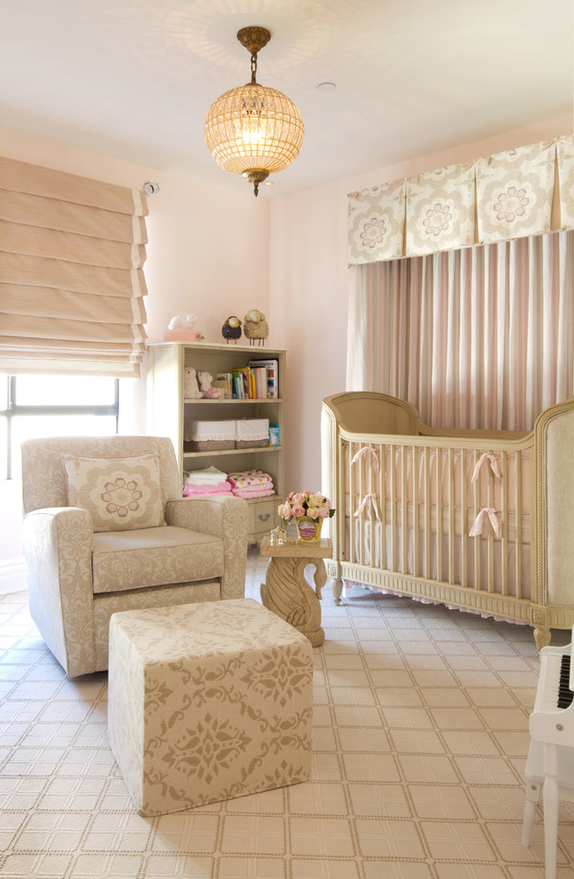 Inspiration for a large transitional nursery for girls in Los Angeles with pink walls and carpet.