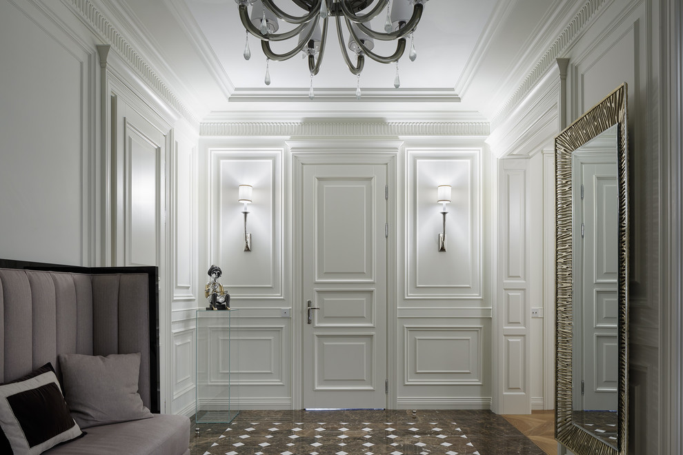 Photo of a mid-sized transitional entry hall in Saint Petersburg with white walls, marble floors, a single front door, a white front door and multi-coloured floor.