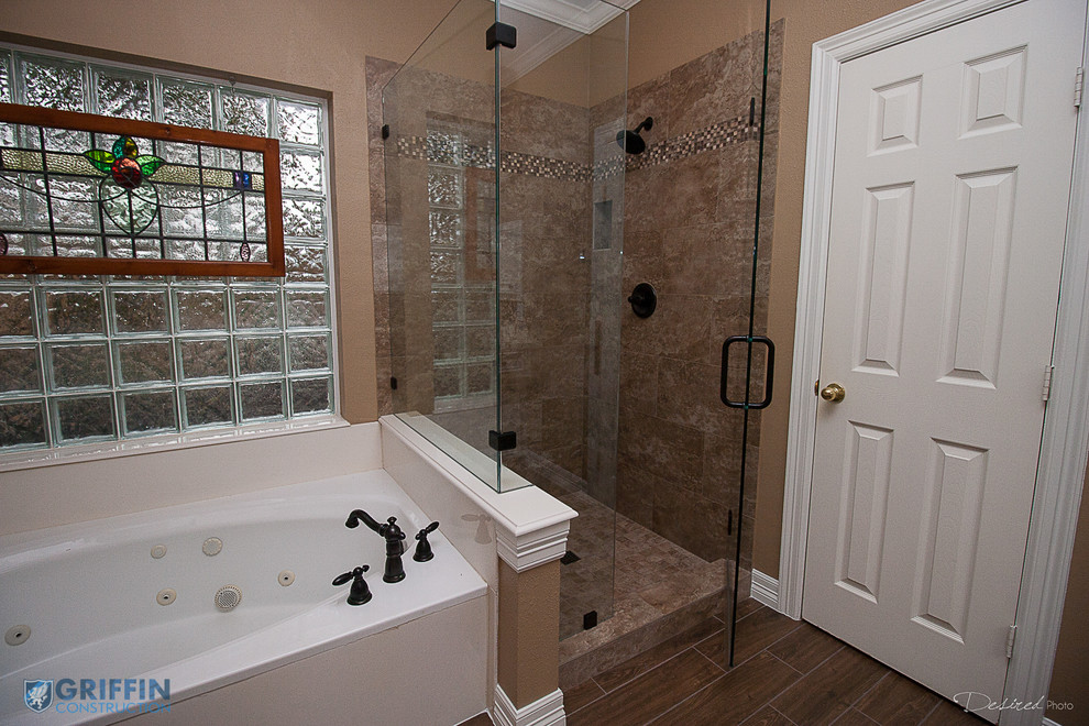 Inspiration for a large traditional master bathroom in Houston with white cabinets, a drop-in tub, a corner shower, brown tile, porcelain tile, beige walls and ceramic floors.