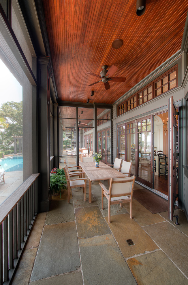 Photo of a traditional screened-in verandah in Charleston with a roof extension.