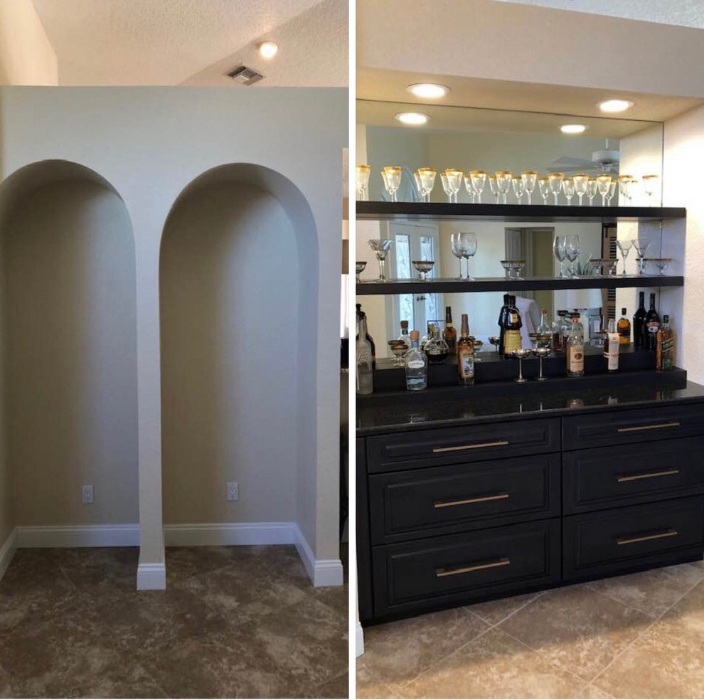 Inspiration for a small transitional single-wall wet bar in Other with no sink, recessed-panel cabinets, black cabinets, granite benchtops, mirror splashback, porcelain floors, beige floor and black benchtop.