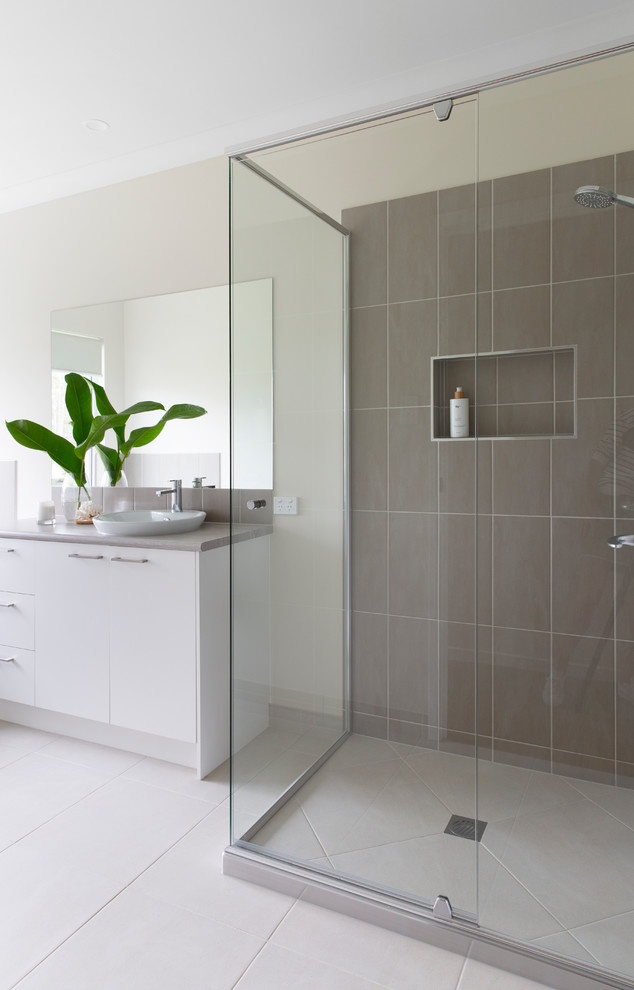 Inspiration for a mid-sized country 3/4 bathroom in Brisbane with flat-panel cabinets, white cabinets, an alcove tub, a corner shower, beige tile, ceramic tile, beige walls, ceramic floors, a drop-in sink, laminate benchtops, white floor, a hinged shower door and beige benchtops.