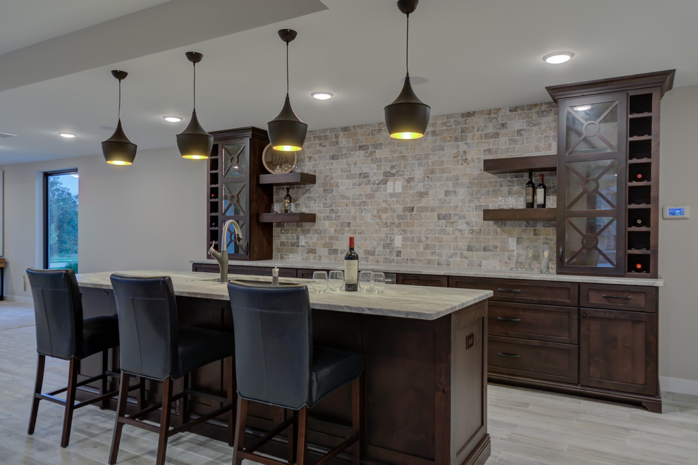 Inspiration for a transitional galley seated home bar in Other with shaker cabinets, dark wood cabinets, quartzite benchtops and beige splashback.