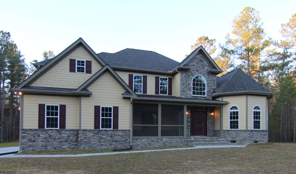 Inspiration for a large transitional two-storey yellow exterior in Raleigh with mixed siding.