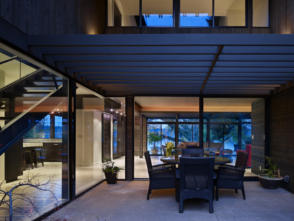 Photo of a contemporary patio in Seattle with a pergola.
