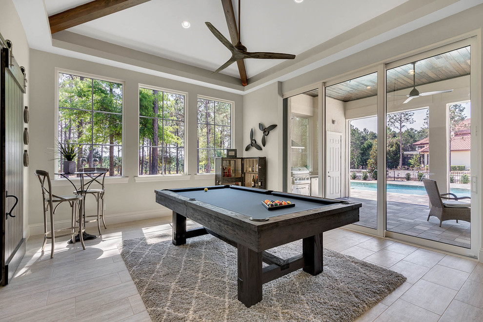 Inspiration for a large transitional family room in Orlando with a game room, grey walls, porcelain floors, a wall-mounted tv and grey floor.