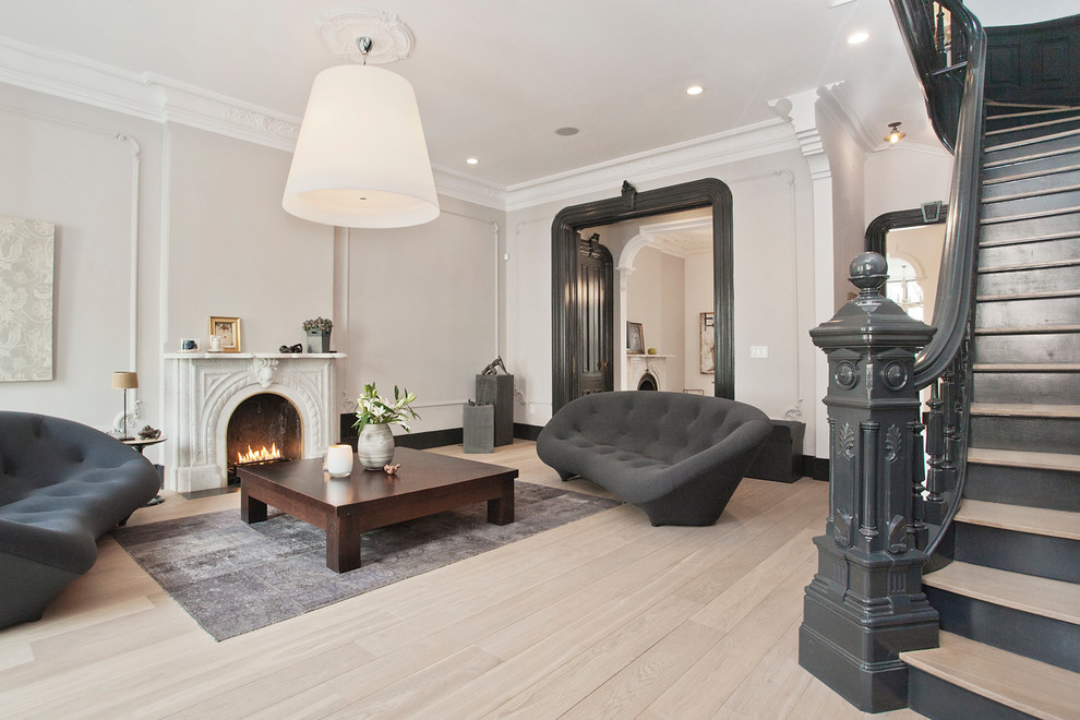 Living room - large scandinavian formal and enclosed light wood floor living room idea in New York with gray walls, a standard fireplace, a stone fireplace and no tv