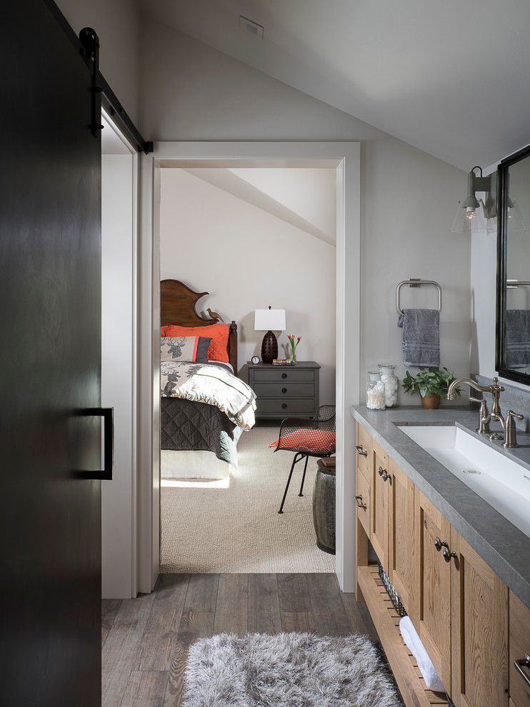Example of a transitional dark wood floor bathroom design with shaker cabinets, medium tone wood cabinets, gray walls, an undermount sink and gray countertops