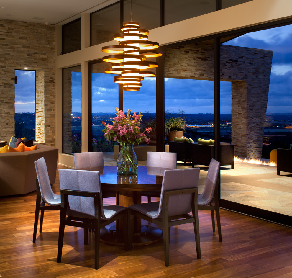 Contemporary open plan dining in San Diego with dark hardwood floors.