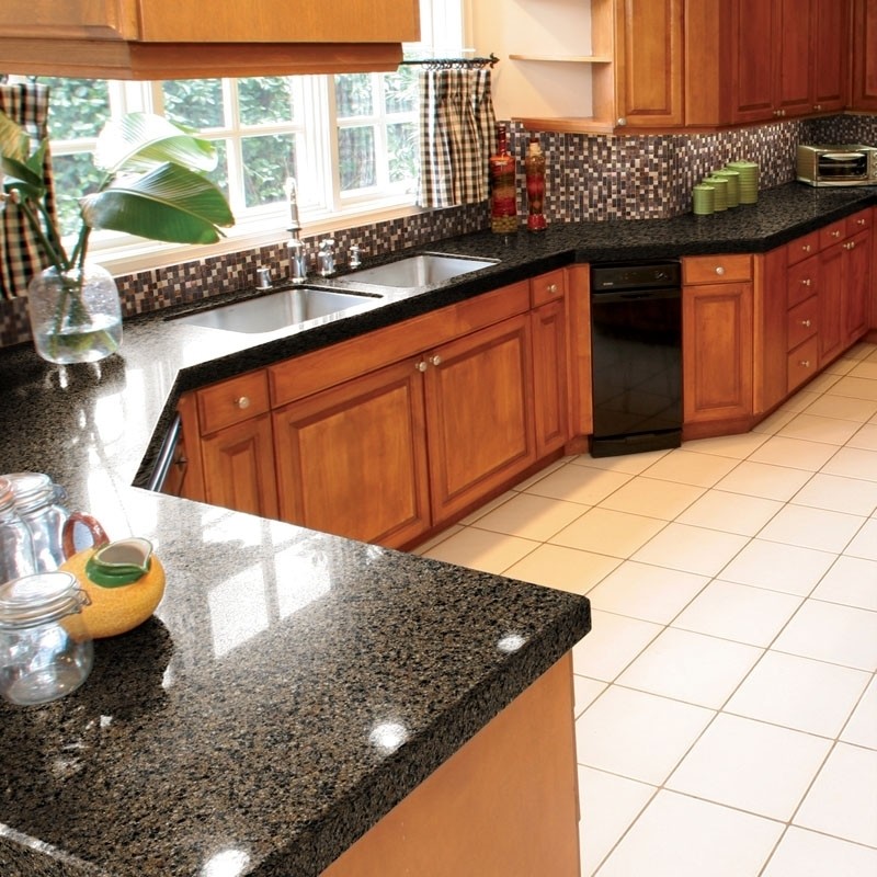 Inspiration for a mid-sized timeless u-shaped ceramic tile enclosed kitchen remodel in Chicago with an undermount sink, raised-panel cabinets, medium tone wood cabinets, granite countertops, black backsplash, mosaic tile backsplash, black appliances and no island