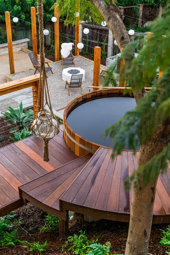 Photo of a large contemporary backyard full sun garden in San Diego with decking.