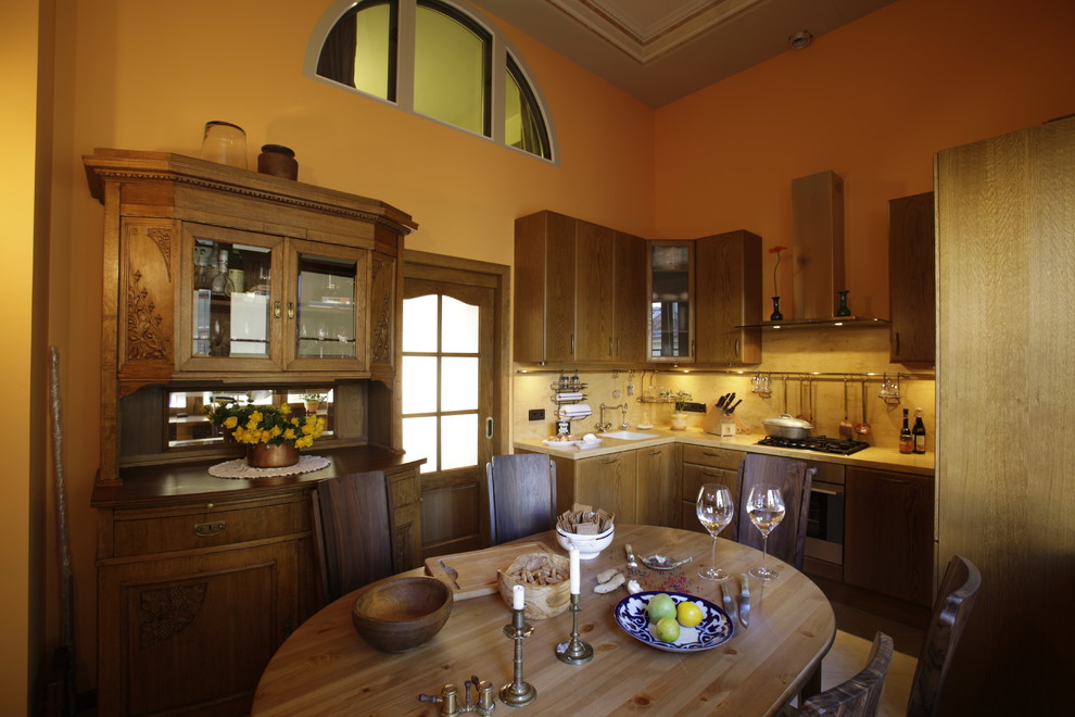Country u-shaped eat-in kitchen in Saint Petersburg with an undermount sink, flat-panel cabinets, brown cabinets, solid surface benchtops, yellow splashback, stainless steel appliances, porcelain floors, beige floor and yellow benchtop.