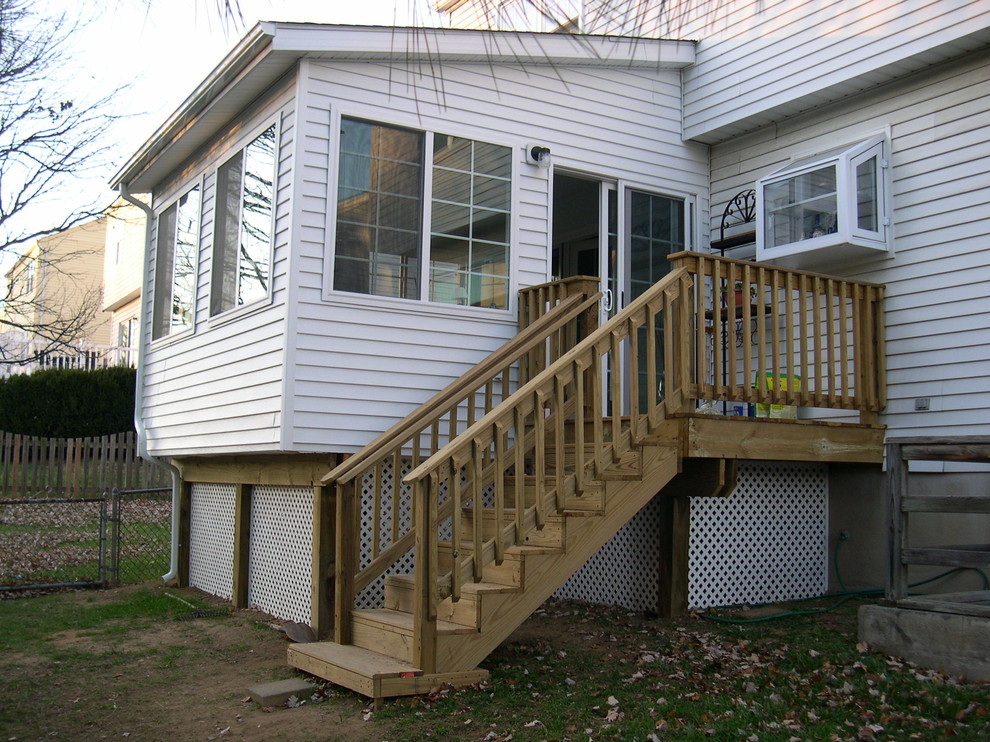 Inspiration for a mid-sized rustic backyard deck remodel in Baltimore with a roof extension