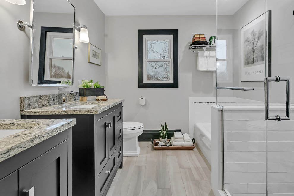 Inspiration for a mid-sized transitional kids' white tile and subway tile wood-look tile floor, beige floor and single-sink bathroom remodel in New York with shaker cabinets, black cabinets, a two-piece toilet, gray walls, an undermount sink, quartz countertops, beige countertops, a niche and a freestanding vanity