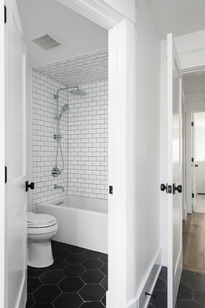 Design ideas for a large country 3/4 bathroom in Chicago with flat-panel cabinets, blue cabinets, an alcove tub, a two-piece toilet, white tile, porcelain tile, white walls, slate floors, an undermount sink, engineered quartz benchtops, black floor, white benchtops, a niche, a double vanity and vaulted.